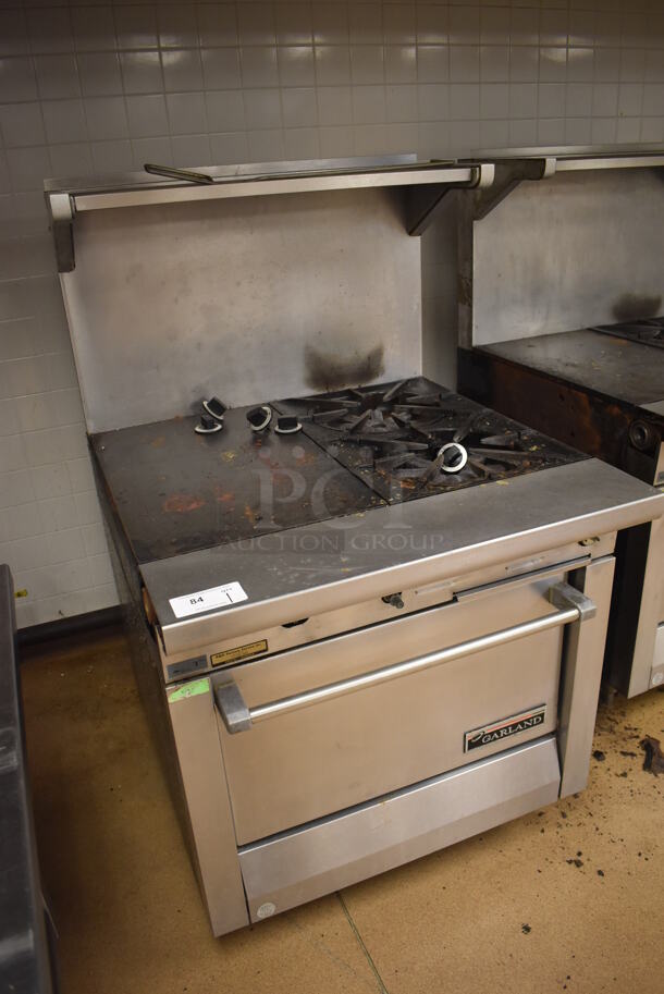 Garland M42-6R Stainless Steel Commercial Natural Gas Powered 2 Burner Range w/ Flat Top, Oven, Over Shelf and Back Splash. BUYER MUST REMOVE. 34x38x58. Tested and Working! (Education Kitchen) - Image 2 of 8