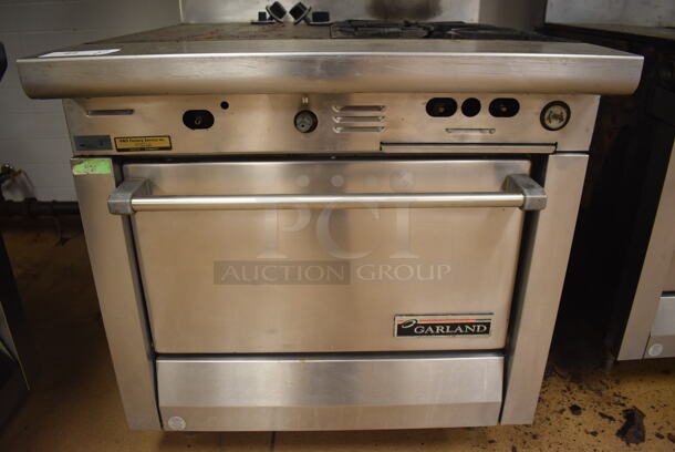 Garland M42-6R Stainless Steel Commercial Natural Gas Powered 2 Burner Range w/ Flat Top, Oven, Over Shelf and Back Splash. BUYER MUST REMOVE. 34x38x58. Tested and Working! (Education Kitchen) - Image 6 of 8