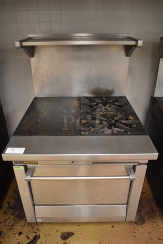 Garland M42-6R Stainless Steel Commercial Natural Gas Powered 2 Burner Range w/ Flat Top, Oven, Over Shelf and Back Splash. BUYER MUST REMOVE. 34x38x58. Tested and Working! (Education Kitchen)