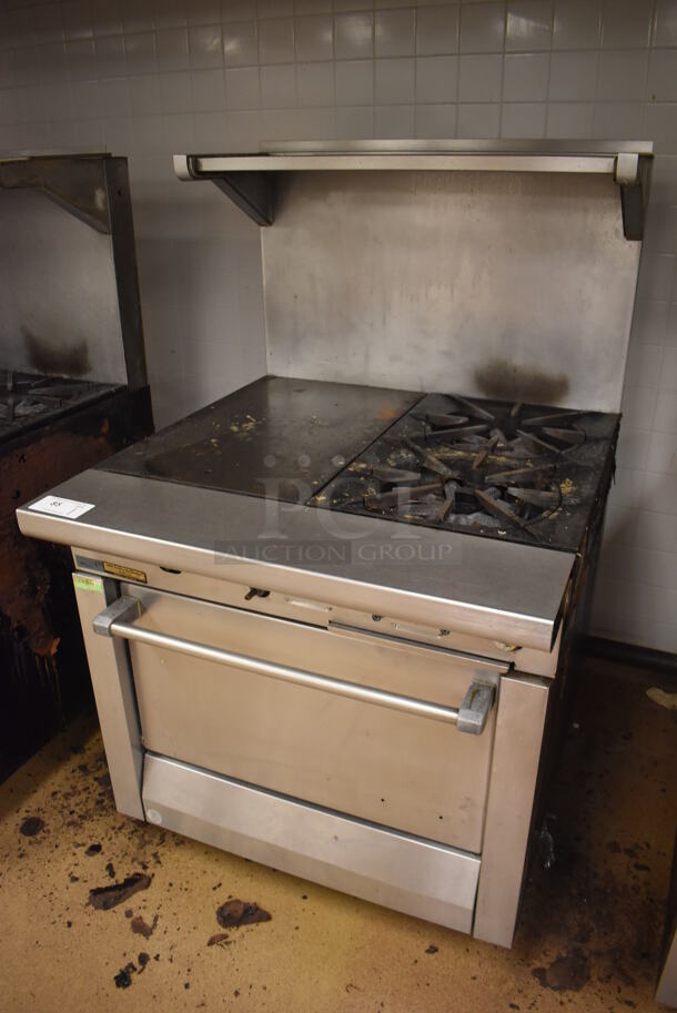 Garland M42-6R Stainless Steel Commercial Natural Gas Powered 2 Burner Range w/ Flat Top, Oven, Over Shelf and Back Splash. BUYER MUST REMOVE. 34x38x58. Tested and Working! (Education Kitchen) - Image 2 of 7