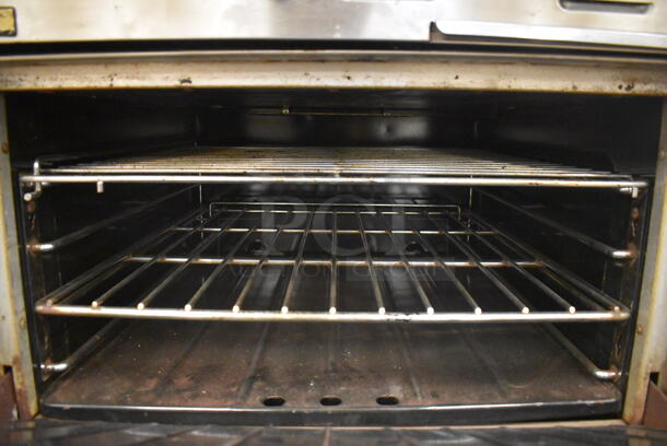Garland M42-6R Stainless Steel Commercial Natural Gas Powered 2 Burner Range w/ Flat Top, Oven, Over Shelf and Back Splash. BUYER MUST REMOVE. 34x38x58. Tested and Working! (Education Kitchen) - Image 6 of 8