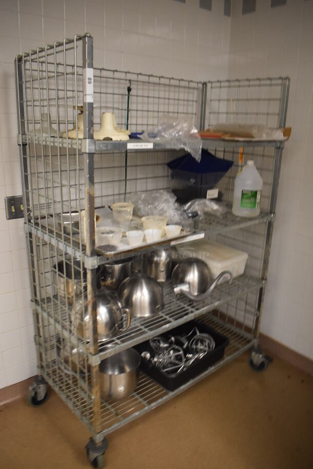 Metal 4 Tier Wire Shelving Unit on Commercial Casters w/ Contents Including Metal Mixing Bowls, Attachments and Cake Stands. BUYER MUST DISMANTLE. PCI CANNOT DISMANTLE FOR SHIPPING. PLEASE CONSIDER FREIGHT CHARGES. 48x24x70. (Education Kitchen)