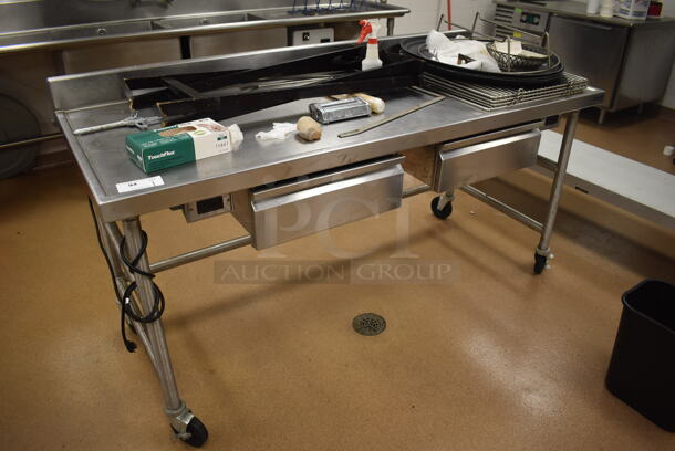 Stainless Steel Table w/ 2 Drawers and Back Splash on Commercial Casters. Comes w/ Contents. 72x30x39. (Education Kitchen)