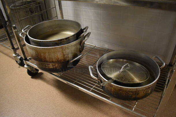 Metal 4 Tier Wire Shelving Unit on Commercial Casters w/ Contents Including Metal Stock Pots and Baking Pans. BUYER MUST DISMANTLE. PCI CANNOT DISMANTLE FOR SHIPPING. PLEASE CONSIDER FREIGHT CHARGES. 48x24x78. (Dishroom) - Image 2 of 6