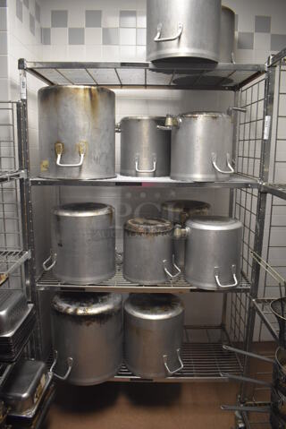 Metal 4 Tier Wire Shelving Unit on Commercial Casters w/ Contents Including Metal Stock Pots. BUYER MUST DISMANTLE. PCI CANNOT DISMANTLE FOR SHIPPING. PLEASE CONSIDER FREIGHT CHARGES. 48x24x78. (Dishroom)