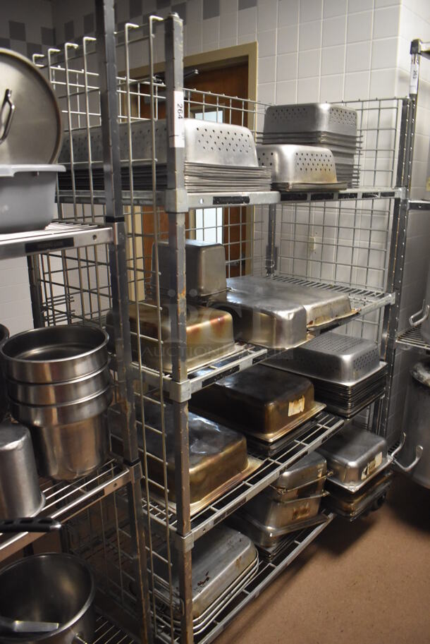 Metal 4 Tier Wire Shelving Unit on Commercial Casters w/ Contents Including Stainless Steel Drop In Bins. BUYER MUST DISMANTLE. PCI CANNOT DISMANTLE FOR SHIPPING. PLEASE CONSIDER FREIGHT CHARGES. 48x24x70. (Dishroom)