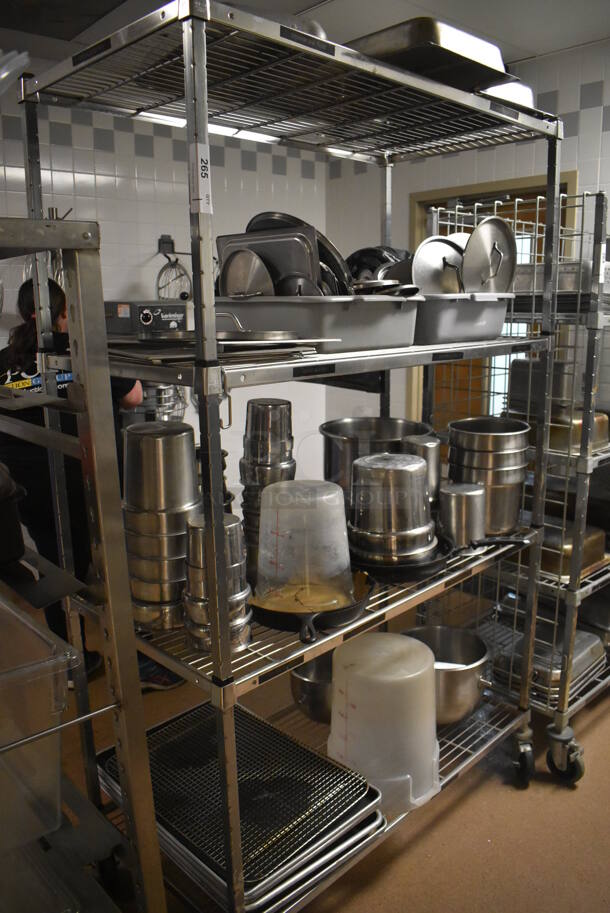 Metal 4 Tier Wire Shelving Unit on Commercial Casters w/ Contents Including Metal Lids, Baking Pans and Cylindrical Drop In Bins. BUYER MUST DISMANTLE. PCI CANNOT DISMANTLE FOR SHIPPING. PLEASE CONSIDER FREIGHT CHARGES. 48x24x78. (Dishroom)
