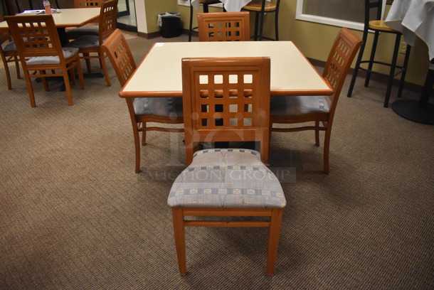 Square Dining Height Table on Black Metal Table Base w/ 4 Wood Pattern Dining Chairs w/ Blue Patterned Seat Cushion. Stock Picture - Cosmetic Condition May Vary. 42x42x29, 19x17x36. (Dining Room)