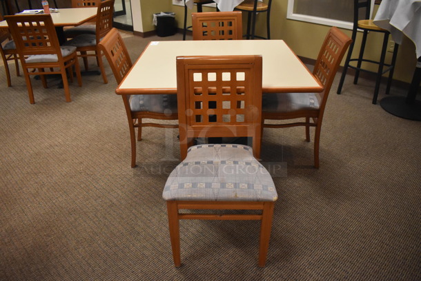 Square Dining Height Table on Black Metal Table Base w/ 4 Wood Pattern Dining Chairs w/ Blue Patterned Seat Cushion. Stock Picture - Cosmetic Condition May Vary. 42x42x29, 19x17x36. (Dining Room) - Image 1 of 6