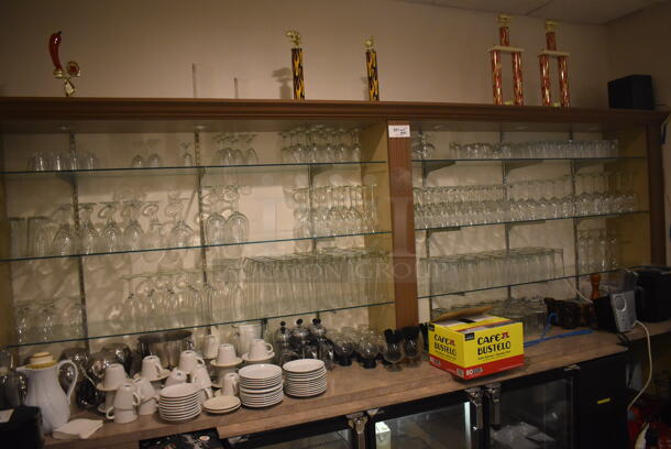ALL ONE MONEY! Lot of Various Glasses on Shelves. Does Not Include Shelves. BUYER MUST REMOVE. (Dining Room)