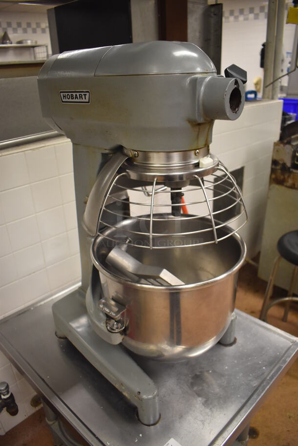 Hobart A200 Metal Commercial Countertop 20 Quart Planetary Dough Mixer w/ 2 Metal Mixing Bowls, Bowl Guard and Paddle Attachment on Stainless Steel Equipment Stand on Commercial Casters. 115 Volts, 1 Phase. 16x23x30, 24x30x29. Tested and Working! Metal Commercial Gas Powered Single Door Smoker on Commercial Casters. BUYER MUST REMOVE. 22x30x56. Tested and Working! (Restaurant Kitchen) - Image 5 of 8