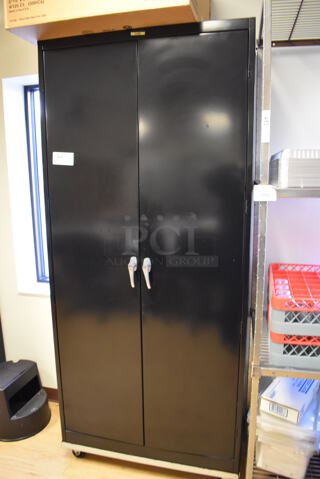 Black Metal 2 Door Cabinet w/ Contents. 36x20x82. (Computer Demo Lab 2)