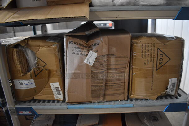 ALL ONE MONEY! Tier Lot of Various Items Including Kleenguard Protective Clothing Box and 2 GGS Collared Poly Elastic Clothes Covering Boxes - Image 1 of 7