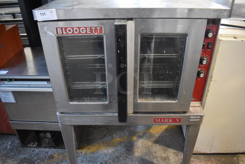 Blodgett Mark V Stainless Steel Commercial Natural Gas Powered Full Size Convection Oven w/ View Through Doors, Metal Oven Racks and Thermostatic Controls on Metal Legs. 38x37x54