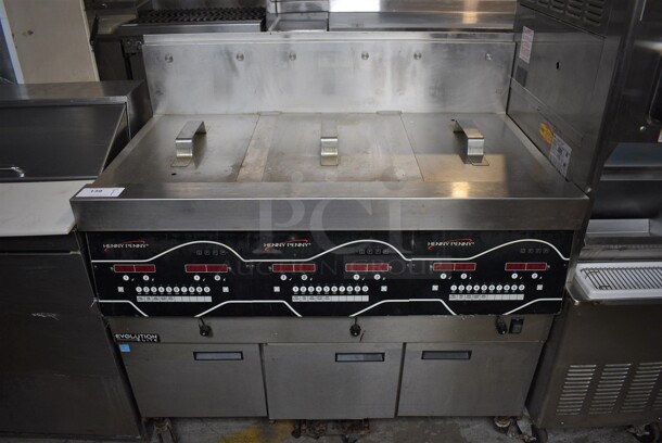 2016 Henny Penny EEG-243 FFFX ST Evolution Elite ENERGY STAR Stainless Steel Commercial Natural Gas Powered 3 Bay Deep Fat Fryer w/ 3 Lids on Commercial Casters. 225,000 BTU. 47x32x46.5
