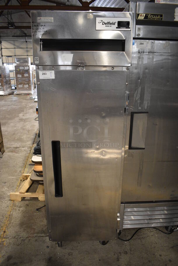 2010 Delfield 6125XL-S-STAR1 ENERGY STAR Stainless Steel Commercial Single Door Reach In Freezer w/ Metal Racks on Commercial Casters. 115 Volts, 1 Phase. 25.5x33.5x79.5. Tested and Working!