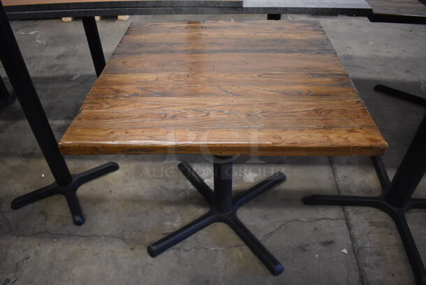 Wooden Bar Height Tables on Black Metal Table Base. Stock Picture - Cosmetic Condition May Vary. 36x36x30
