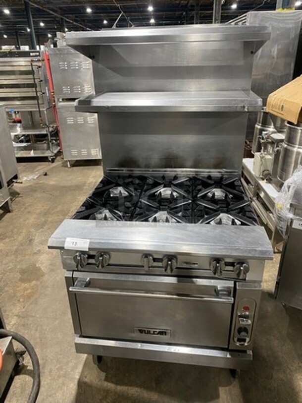 Vulcan Commercial Natural Gas Powered 6 Burner Stove! With Raised Back Splash And Double Overhead Shelves! With Full Size Oven Underneath! Metal Oven Rack! All Stainless Steel! On Casters!