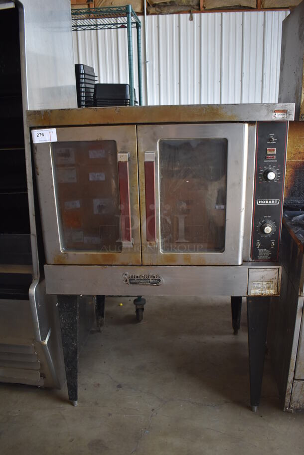 Hobart Stainless Steel Commercial Natural Gas Powered Full Size Convection Oven w/ View Through Doors, Metal Oven Racks and Thermostatic Controls on Metal Legs. 40x32x58