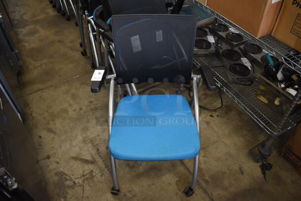 6 Black and Blue Foldable Chairs w/ Arm Rests on Casters. Stock Picture - Cosmetic Condition May Vary. 24x23x36. 6 Times Your Bid!