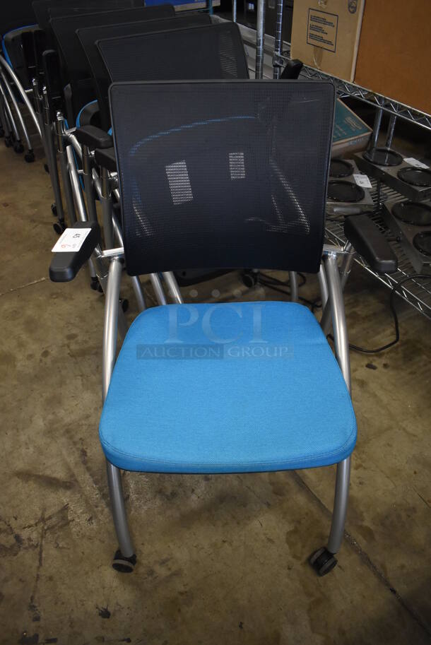 6 Black and Blue Foldable Chairs w/ Arm Rests on Casters. Stock Picture - Cosmetic Condition May Vary. 24x23x36. 6 Times Your Bid! - Image 2 of 6