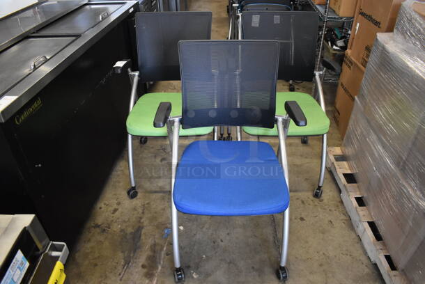 3 Foldable Chairs w/ Arm Rests on Casters. 2 Green and 1 Blue. Stock Picture - Cosmetic Condition May Vary. 24x23x36. 3 Times Your Bid!