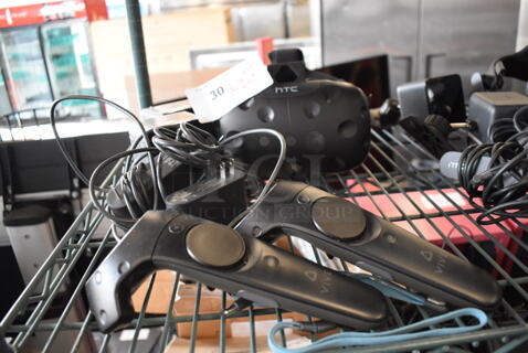 HTC VR Headset w/ 2 HTC Controllers,  2 HTC 2PR8100 Vive Base Stations and 2 Base Station Chargers. 9x12x6, 4.5x5x9, 3.5x2.5x3.5