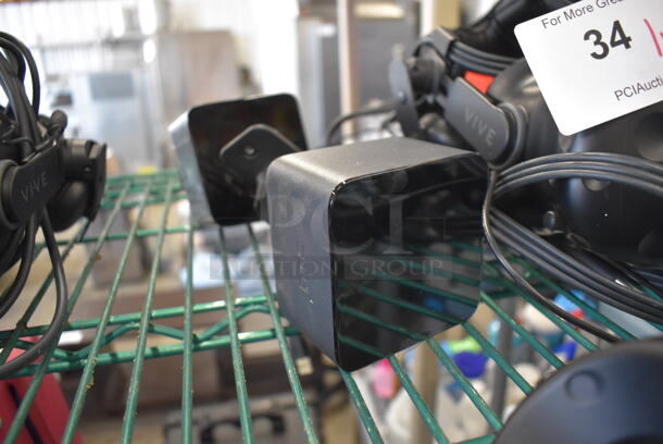 HTC VR Headset w/ 2 HTC Controllers,  2 HTC 2PR8100 Vive Base Stations and 2 Base Station Chargers. 9x12x6, 4.5x5x9, 3.5x2.5x3.5 - Image 4 of 5