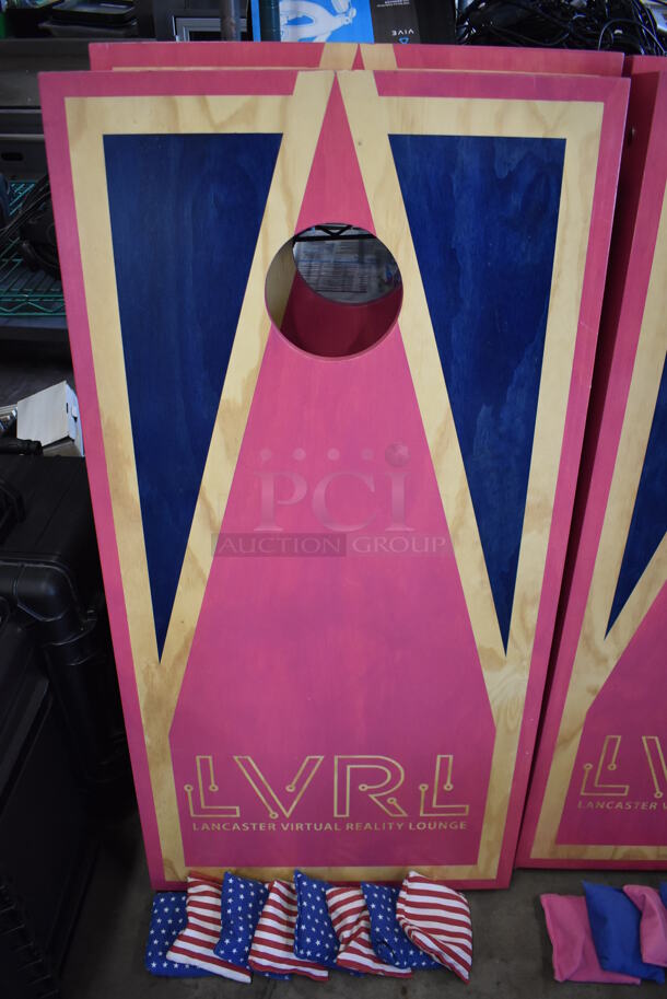 2 Wooden Pink and Blue LVRL Corn Hole Boards w/ 2 Blue Wooden Burky Boards, 4 Blue Starred Bean Bags and 4 Red and White Striped Bean Bags. 24x48x4, 23x23x39, 23x23x63. 2 Times Your Bid! - Image 1 of 6