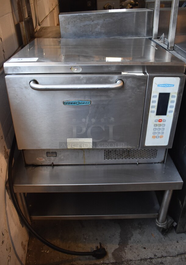 Turbochef NGC Stainless Steel Commercial Countertop Electric Powered Rapid Cook Oven on Stainless Steel Equipment Stand w/ Commercial Casters. Missing 2 Casters. 208/240 Volts, 1 Phase. 30x30x37