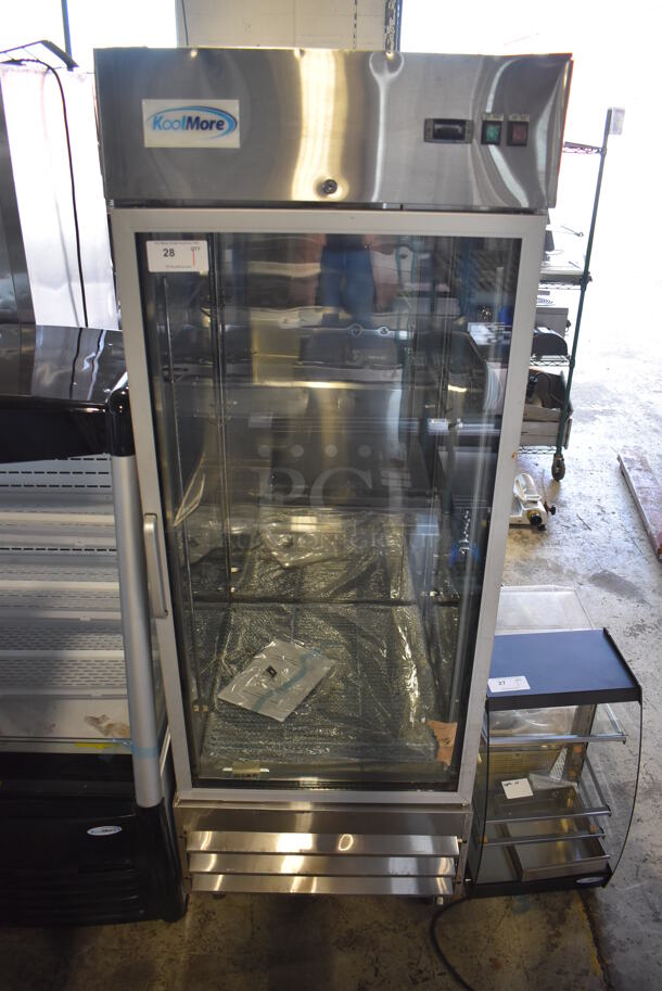 BRAND NEW SCRATCH AND DENT! KoolMore RIR-1D-GD Stainless Steel Commercial Single Door Reach In Cooler Merchandiser w/ Poly Coated Racks on Commercial Casters. 115 Volts, 1 Phase. 29x32x83. Tested and Working! - Image 1 of 7