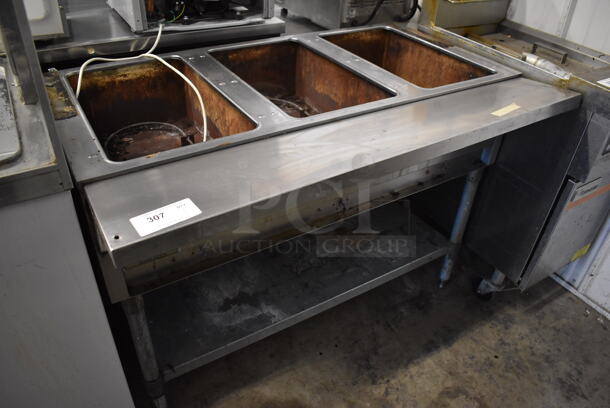 Eagle Stainless Steel Commercial Floor Style Electric Powered 3 Well Steam Table w/ Metal Under Shelf. 125 Volts, 1 Phase. 48x30.5x34. Tested and Powers On, Left Two Bays Are Working But Right Bay Does Not Get Warm