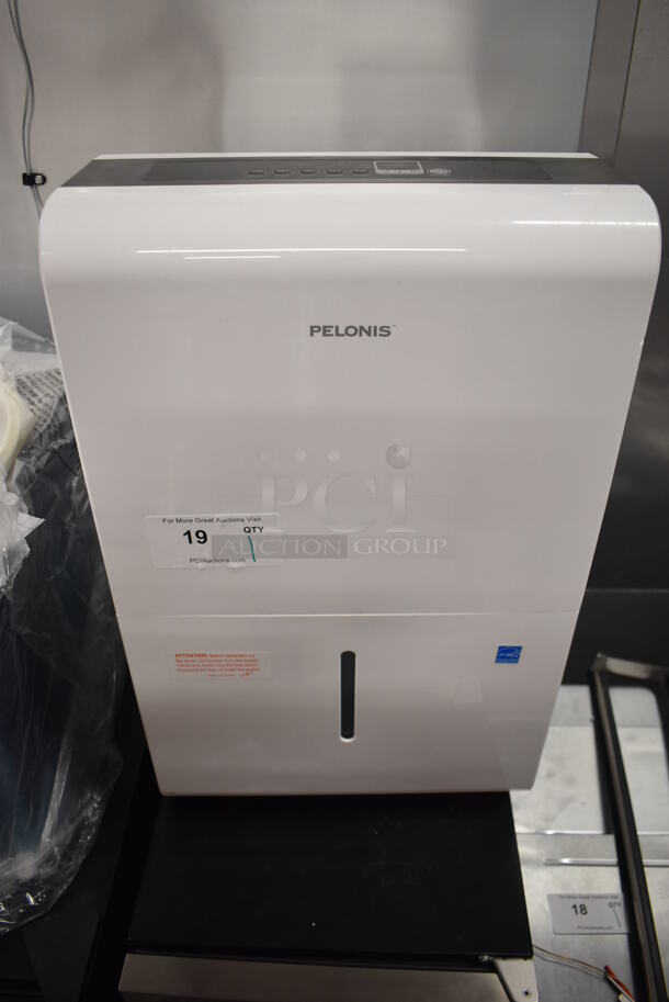 BRAND NEW SCRATCH AND DENT! Pelonis PAD40C1AWT Metal Portable Dehumidifier on Casters. 115 Volts, 1 Phase. 15.5x11x24. Tested and Working!