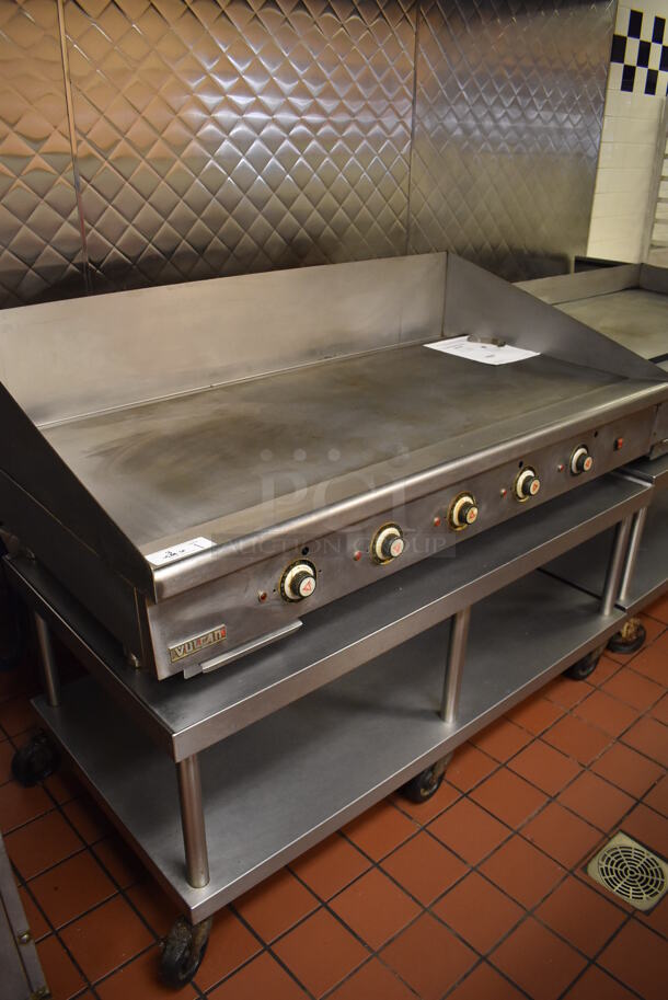 Vulcan Stainless Steel Commercial Countertop Natural Gas Powered Flat Top Griddle w/ Thermostatic Controls on Stainless Steel Equipment Stand w/ Under Shelf and Commercial Casters. Unit Was In Working Condition When Restaurant Closed. BUYER MUST REMOVE. (Front Kitchen)