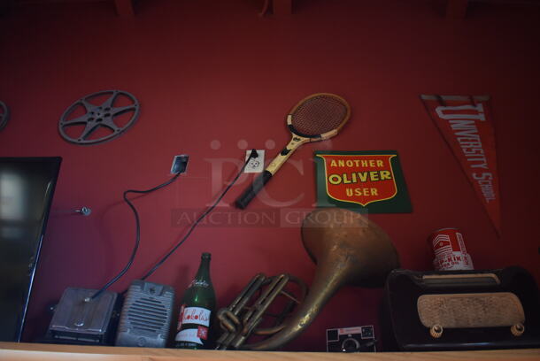 ALL ONE MONEY! Shelf Lot of Various Items Including Bottles and Helmet and Wall Decor Above The Shelf. Does Not Include The Shelf Itself or The Television. BUYER MUST REMOVE. (Dining Room) - Image 3 of 4