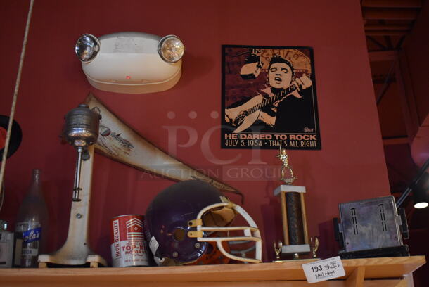 ALL ONE MONEY! Shelf Lot of Various Items Including Helmet, Fan and Trophy and Wall Decor Above The Shelf. Does Not Include The Shelf Itself or The Television. BUYER MUST REMOVE. (Dining Room) - Image 2 of 5