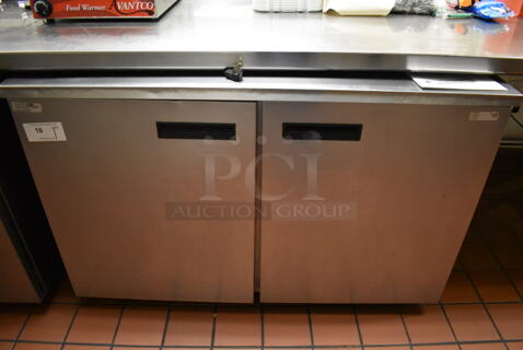 2012 Delfield UC4048 Stainless Steel Commercial 2 Door Undercounter Cooler on Commercial Casters. 115 Volts, 1 Phase. Unit Was In Working Condition When Restaurant Closed. (Front Kitchen)