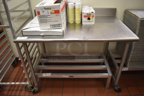 Metal Table w/ Back Splash on Commercial Casters. (Front Kitchen)