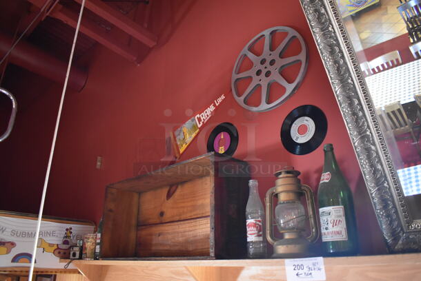ALL ONE MONEY! Shelf Lot of Various Items Including Bottles and Lantern and Wall Decor Above The Shelf. Does Not Include The Shelf Itself. BUYER MUST REMOVE. (Dining Room) - Image 1 of 4
