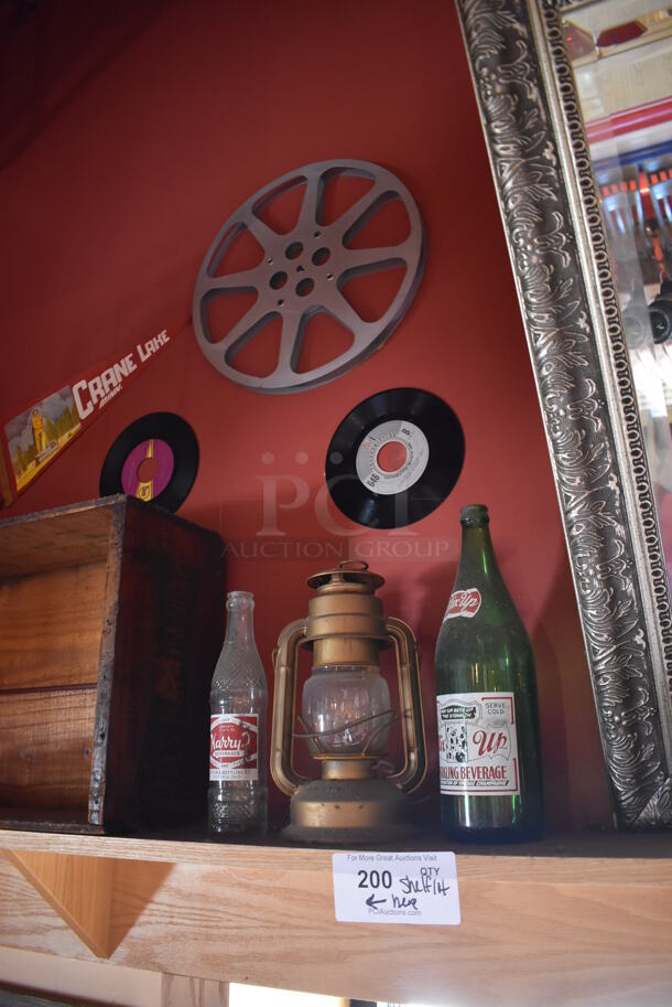 ALL ONE MONEY! Shelf Lot of Various Items Including Bottles and Lantern and Wall Decor Above The Shelf. Does Not Include The Shelf Itself. BUYER MUST REMOVE. (Dining Room) - Image 2 of 4