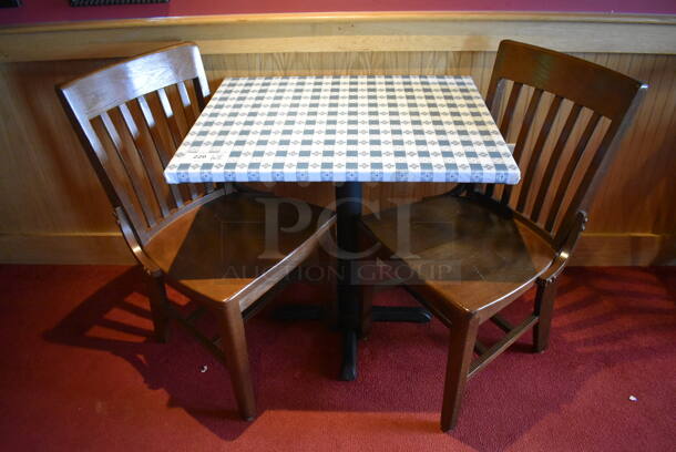 Table w/ Table Cloth on Black Metal Table Base and 2 Wooden Dining Chairs. 30x24x29, 18x16x35. (Party Dining Room)