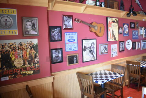 ALL ONE MONEY! Wall Lot of Various Pictures Including Actors, Elvis, Clint Eastwood and Guitar. BUYER MUST REMOVE. (Party Dining Room)
