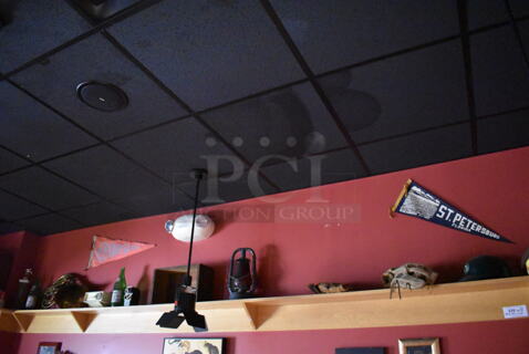 ALL ONE MONEY! Shelf Lot of Various Items Including Bottles and Hats and Wall Decor Above The Shelf. Does Not Include The Shelf Itself. BUYER MUST REMOVE. (Party Dining Room)