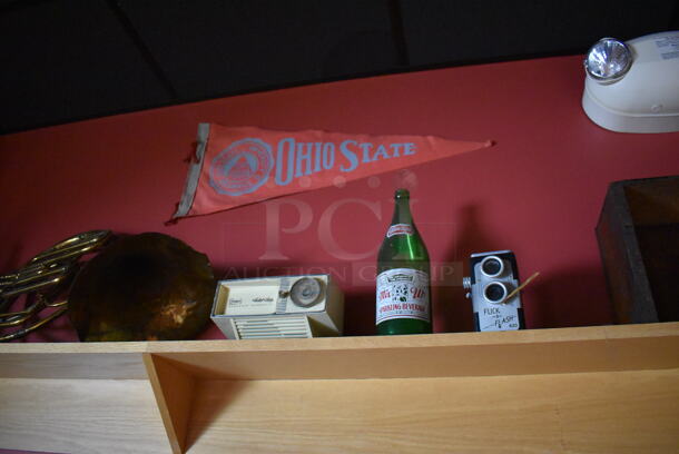 ALL ONE MONEY! Shelf Lot of Various Items Including Bottles and Hats and Wall Decor Above The Shelf. Does Not Include The Shelf Itself. BUYER MUST REMOVE. (Party Dining Room) - Image 5 of 8