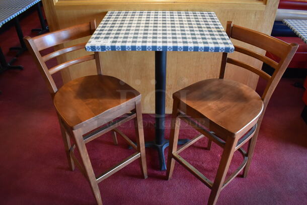 Bar Height Table w/ Table Cloth on Black Metal Table Base and 2 Wooden Bar Height Chairs. 30x24x41, 17x16x44. (Dining Room)

