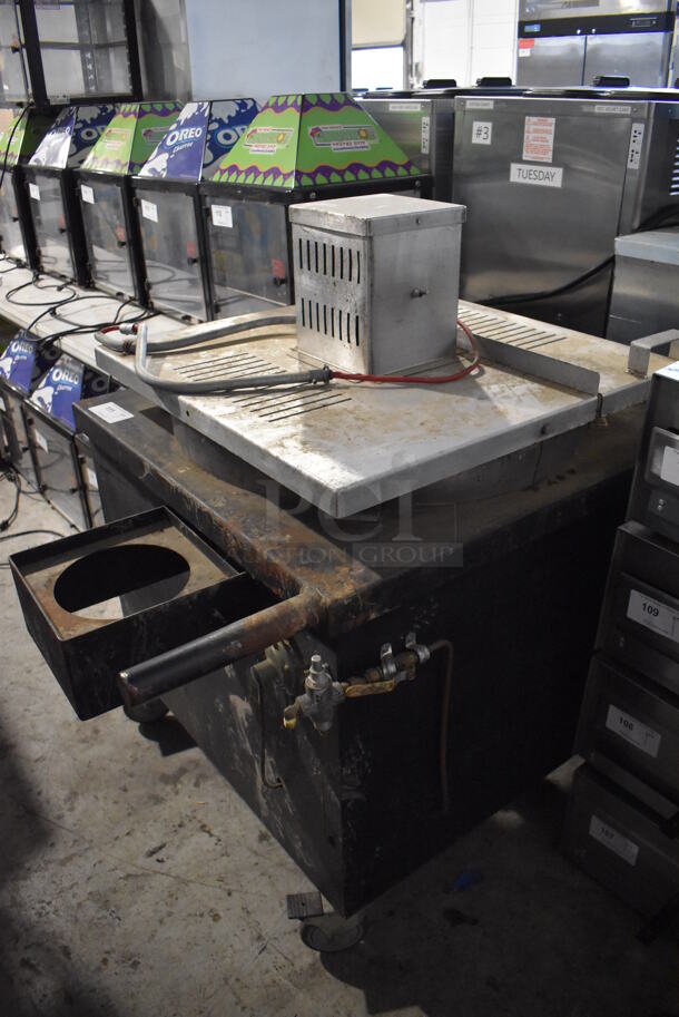Metal Commercial Natural Gas Powered Floor Style Unit on Commercial Casters. Unit Appears To Be Used for Making Large Caramel Popcorn Batches But We Are Not Able To Verify That Information. 35x50x49
