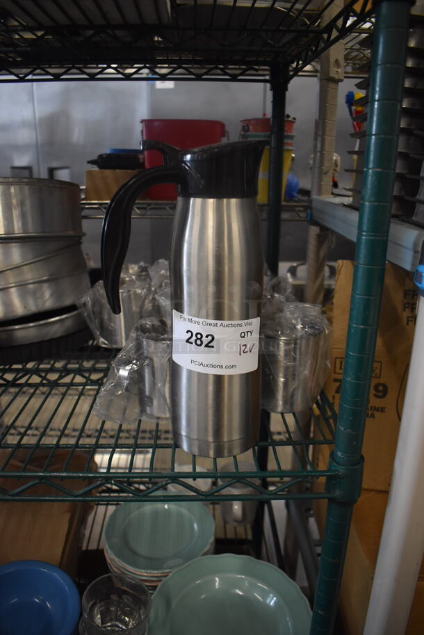 ALL ONE MONEY! Lot of 12 Items Including One Stainless Steel Carafe Server With Black Top and Handle And Stainless Steel Cups With Handles.  - Image 1 of 3