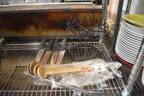 ALL ONE MONEY! Lot of 9 Items Including Plastic Ladles, Steel Serrated Knives With Black Handles, Metal Tongs And a Decorative Black Stand. 