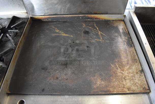 Garland Natural Gas Powered Commercial Stainless Steel Oven With Steel Racks And Top Griddle With Overshelf On Galvanized Legs.  - Image 4 of 7