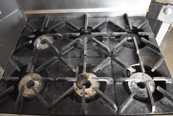 Jade Range Commercial Stainless Steel Natural Gas Powered Oven With 6 Gas Burners And Salamander Broiler and Salamander Shelves On Commercial Casters.  - Image 4 of 9